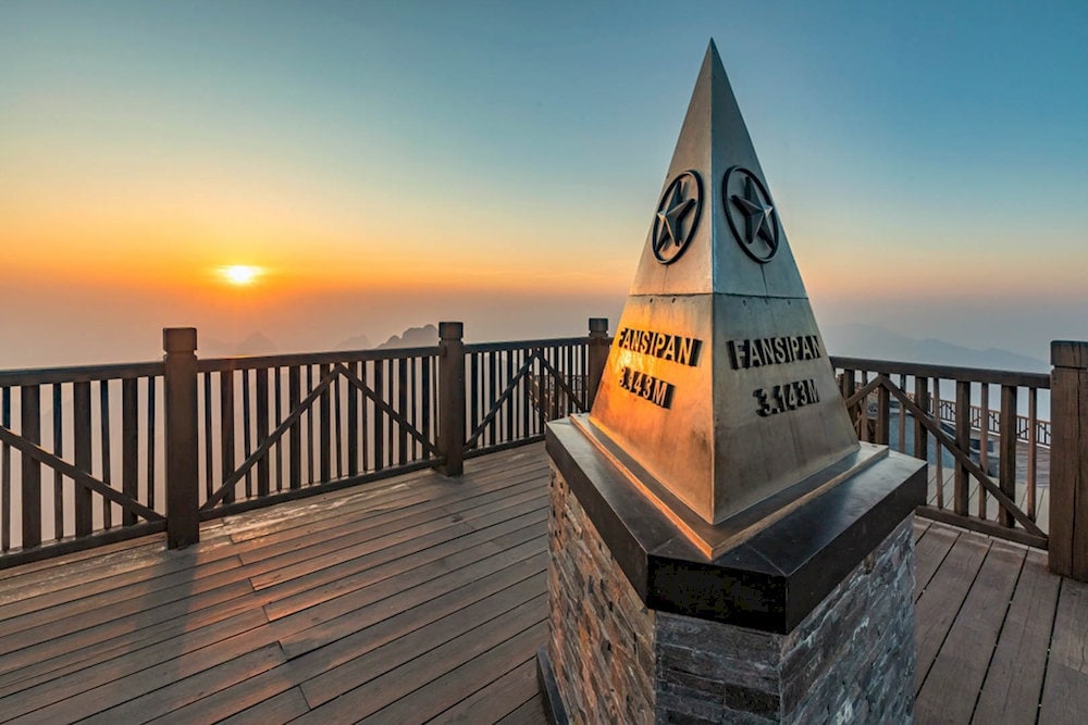 Standing atop Fansipan Mountain, visitors enjoy spectacular views across the best places to visit in Sapa and the entire Indochina region